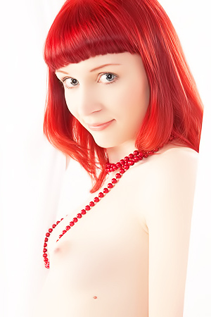 Ginger babe caresses sweet body with beads.