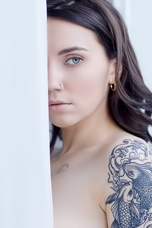 Dannielas naked form tempts behind the sheer curtain as her curves capture attention