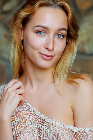 Kelly Collins bares all solo, teasing in lace on a wooden chair